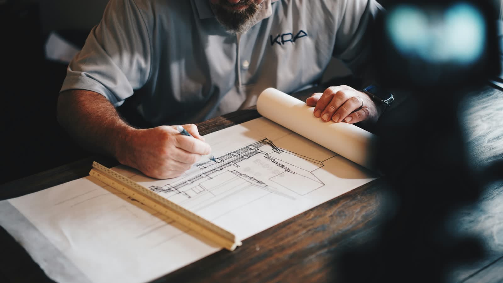 Engineer calculating dosage over a technical drawing